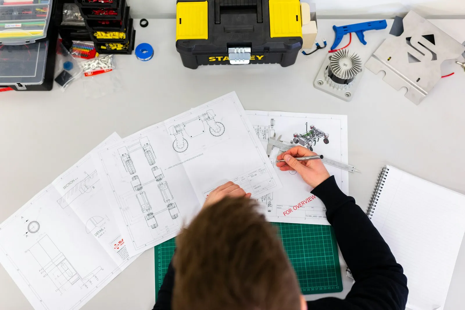 Technician double-checking project measurements and drawings