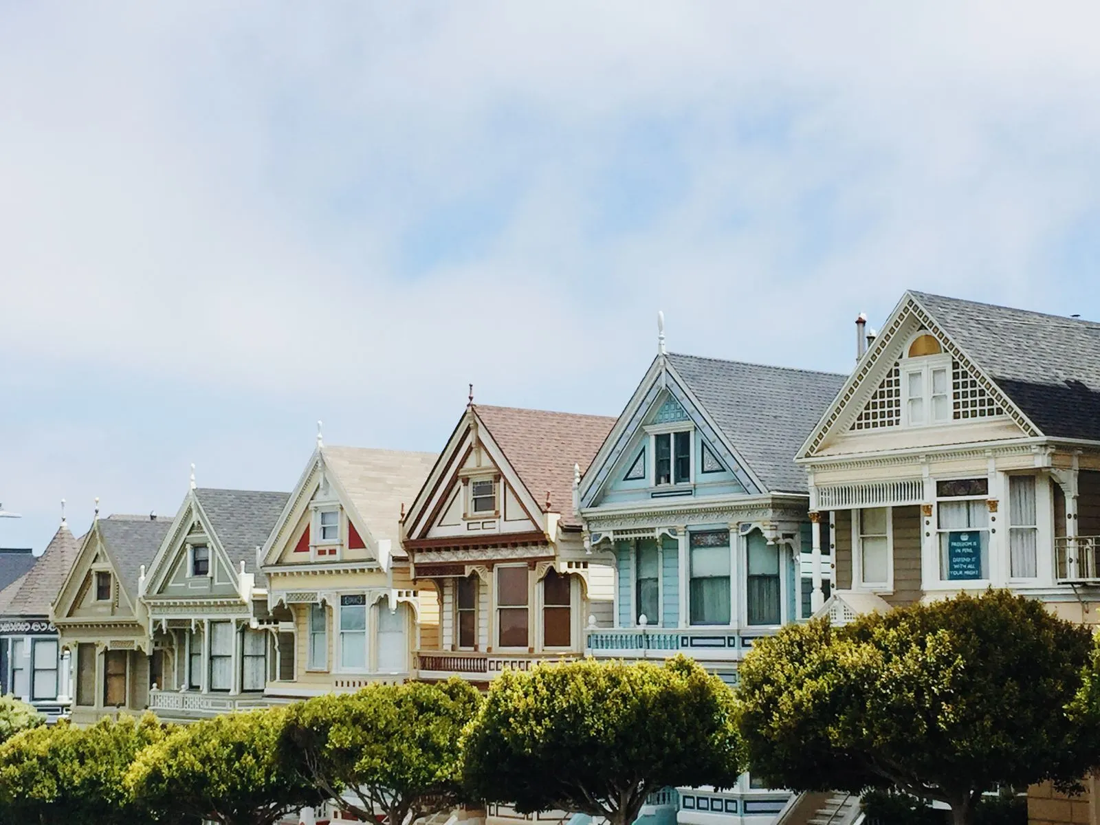 Row of well-kept older homes with character-matched windows